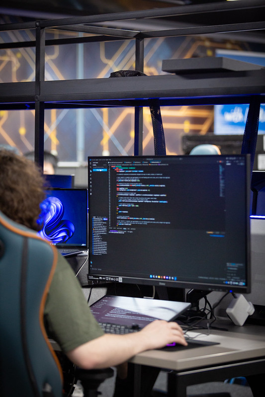 Students studying Computer Games Technology. A student is facing a PC monitor containing code.